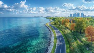 Coastal Road 4K Desktop Wallpaper: Lakefront View with City Skyline
